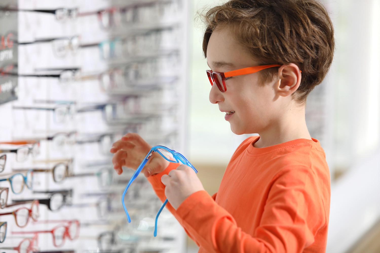 Child choosing glasses in an opticians