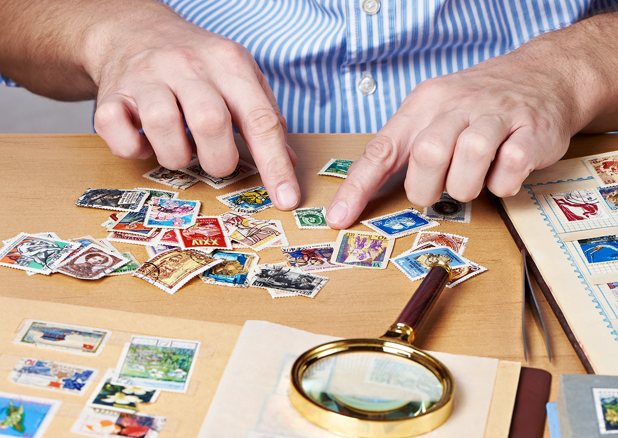 Someone sorting stamps